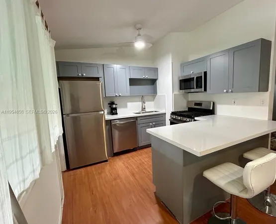 a kitchen with stainless steel appliances a refrigerator stove microwave and sink