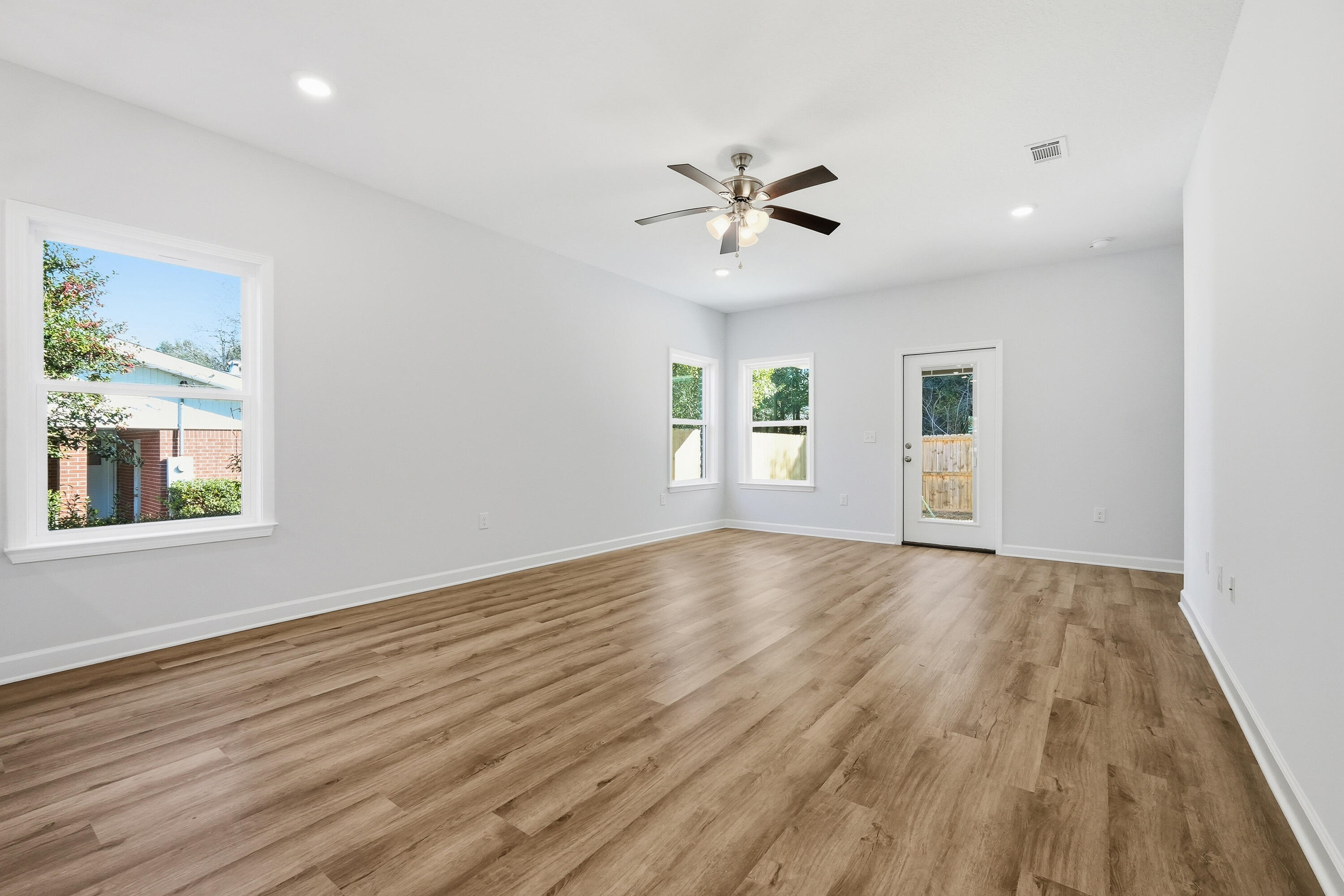 71 Spooner Street DeFuniak Springs, FL 32433 - Photo 11 of 22 a view of empty room with wooden floor and fan