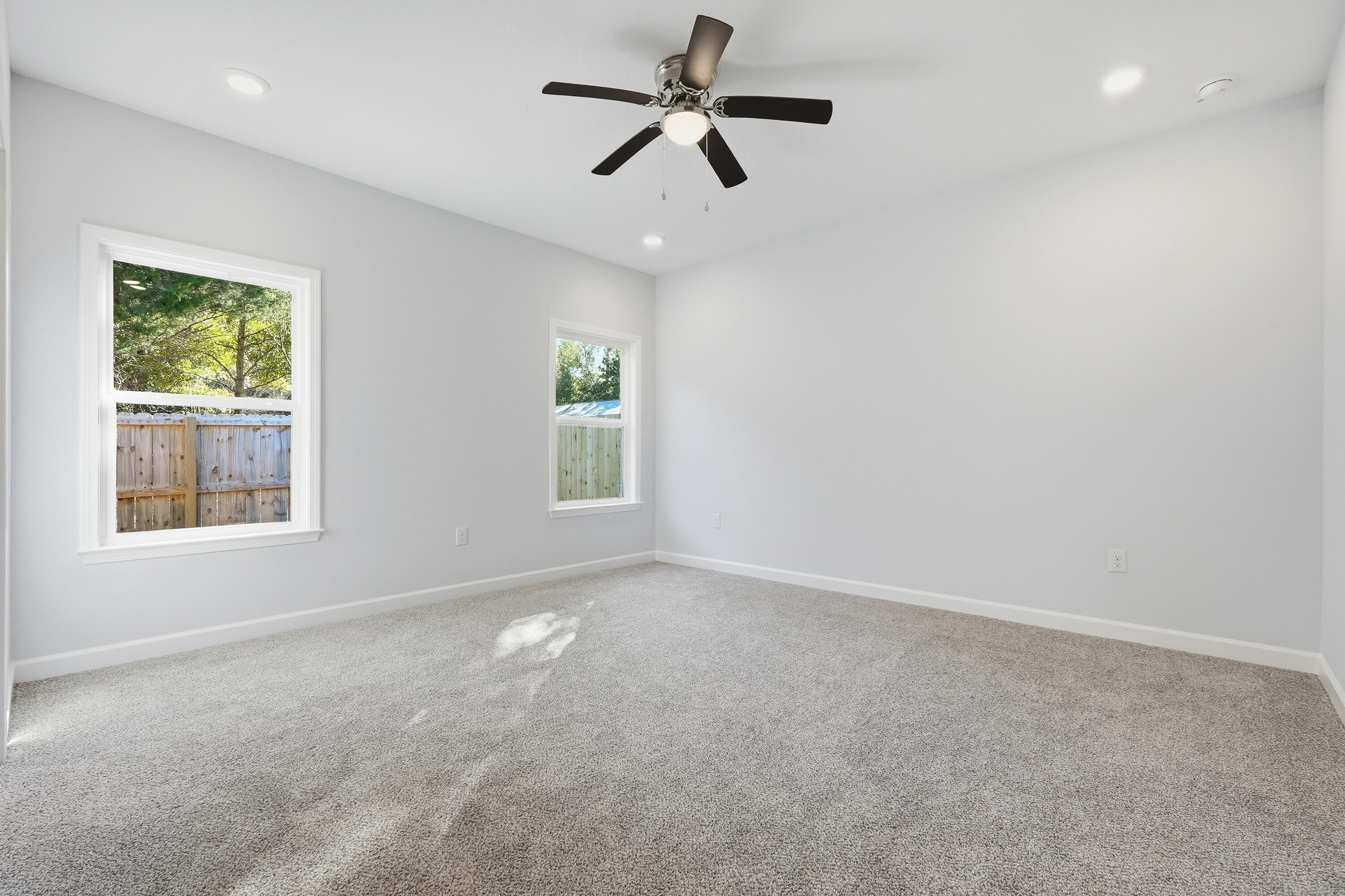 71 Spooner Street DeFuniak Springs, FL 32433 - Photo 13 of 22 an empty room with windows and fan