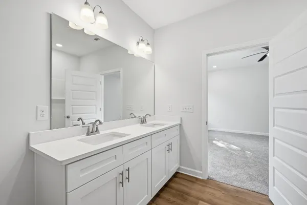 a bathroom with 2 sink and a mirror