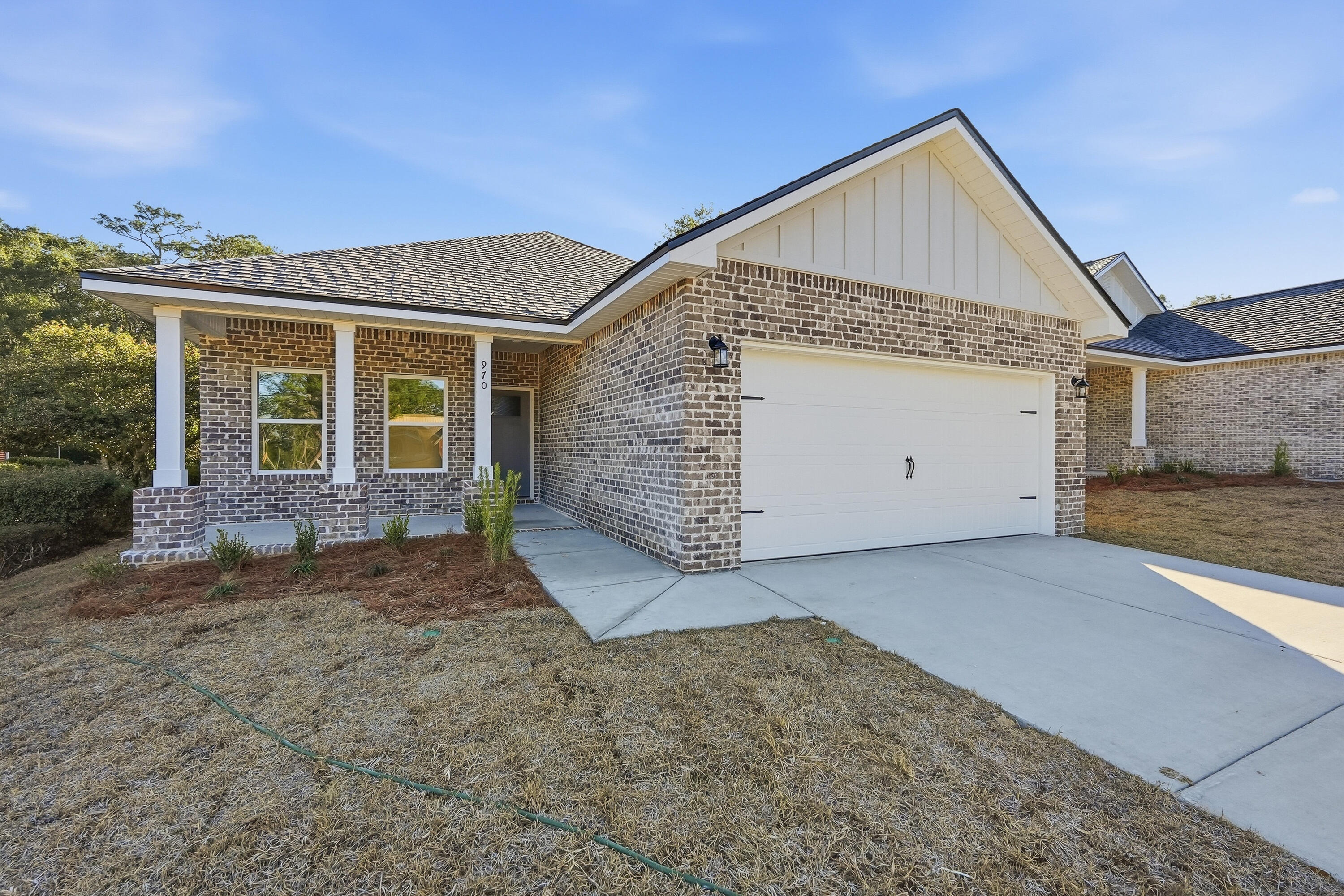 71 Spooner Street DeFuniak Springs, FL 32433 - Photo 2 of 22 a view of a house with a garage and balcony