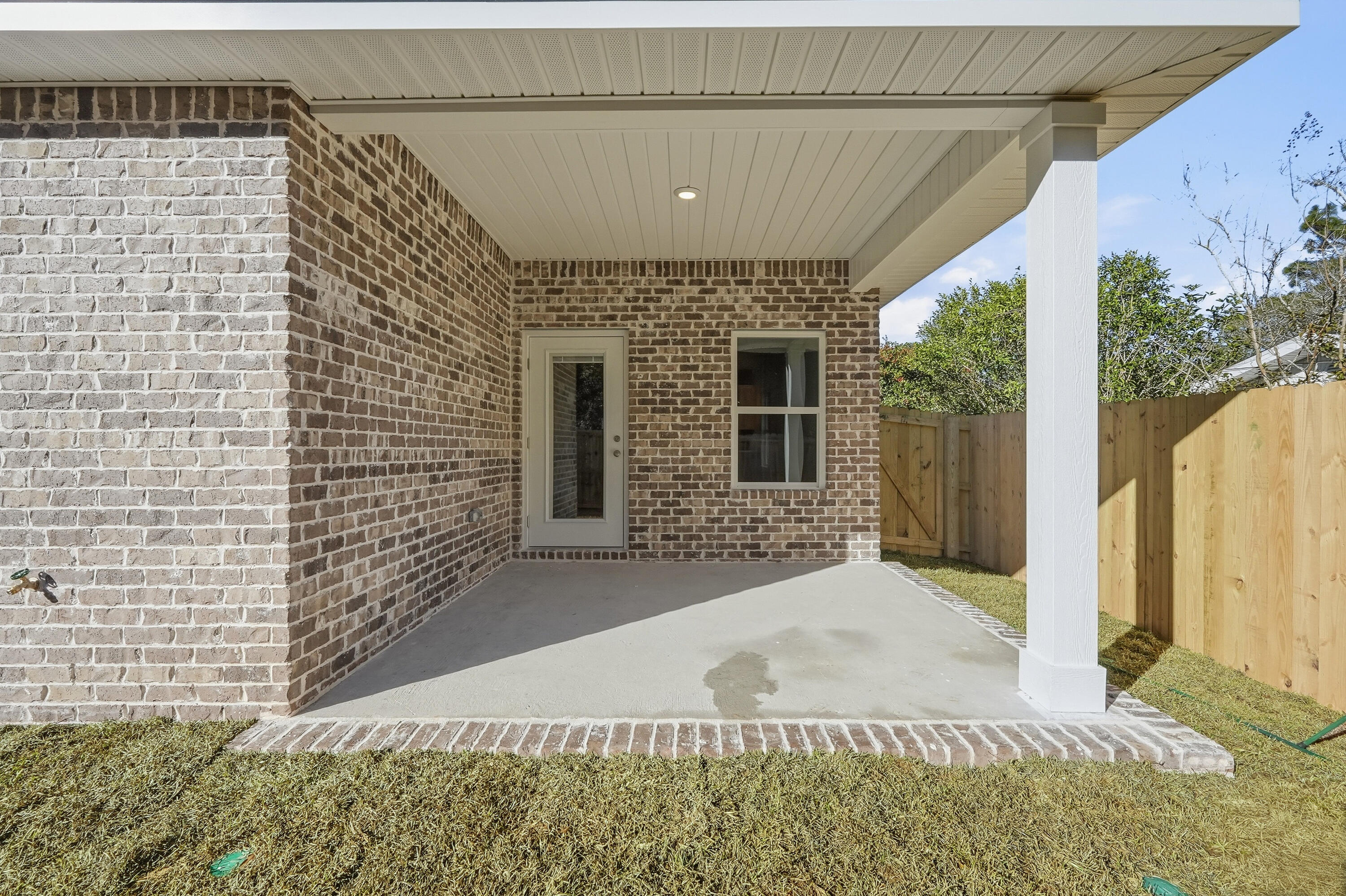 71 Spooner Street DeFuniak Springs, FL 32433 - Photo 22 of 22 a front view of a house with a yard