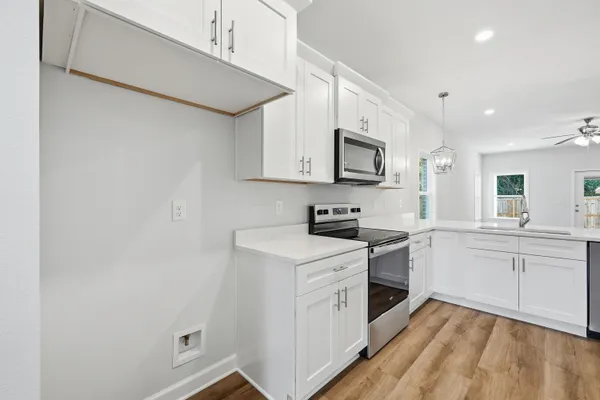a kitchen with a stove top oven sink and cabinets
