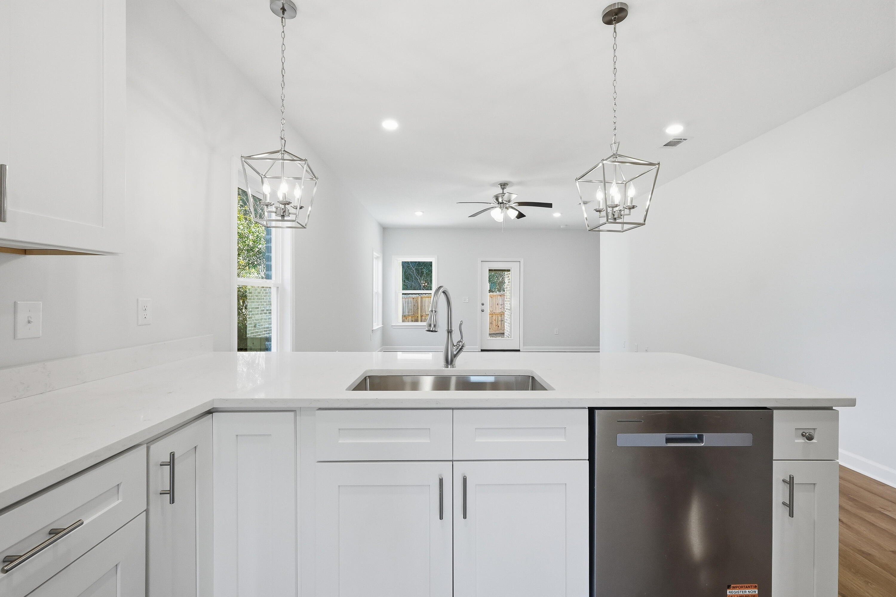 71 Spooner Street DeFuniak Springs, FL 32433 - Photo 7 of 22 a view of a double sink and chandelier in a kitchen