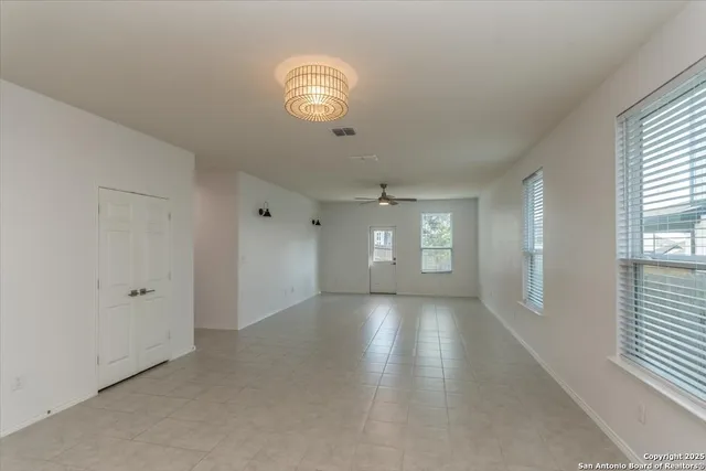 an empty room with windows and entrance