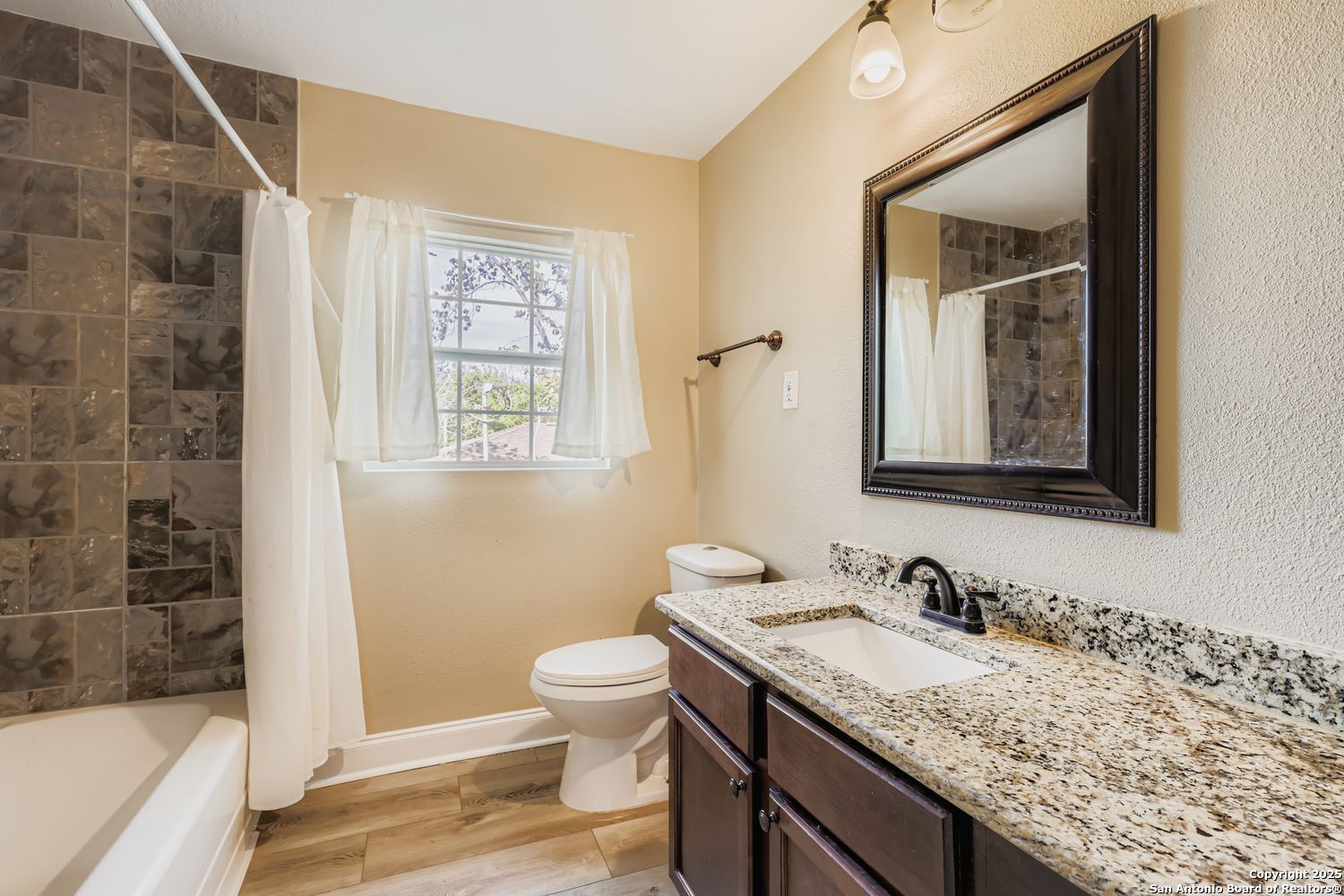 800 Terrell Road San Antonio, TX 78209 - Photo 17 of 28 a bathroom with a granite countertop sink toilet and shower