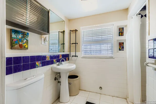 a bathroom with a sink a mirror and a shower