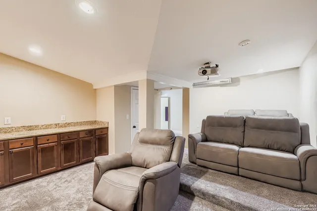 a living room with furniture and a kitchen
