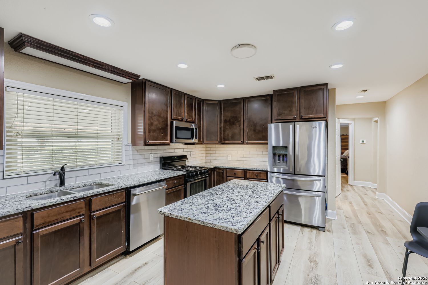 800 Terrell Road San Antonio, TX 78209 - Photo 3 of 28 a kitchen with stainless steel appliances granite countertop a sink stove refrigerator and cabinets