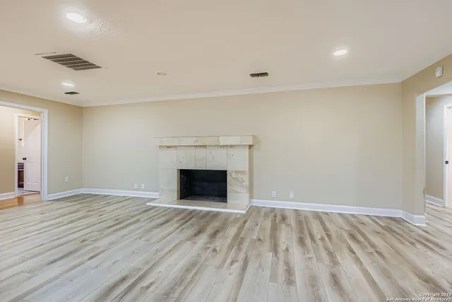 wooden floor in an empty room with a fireplace