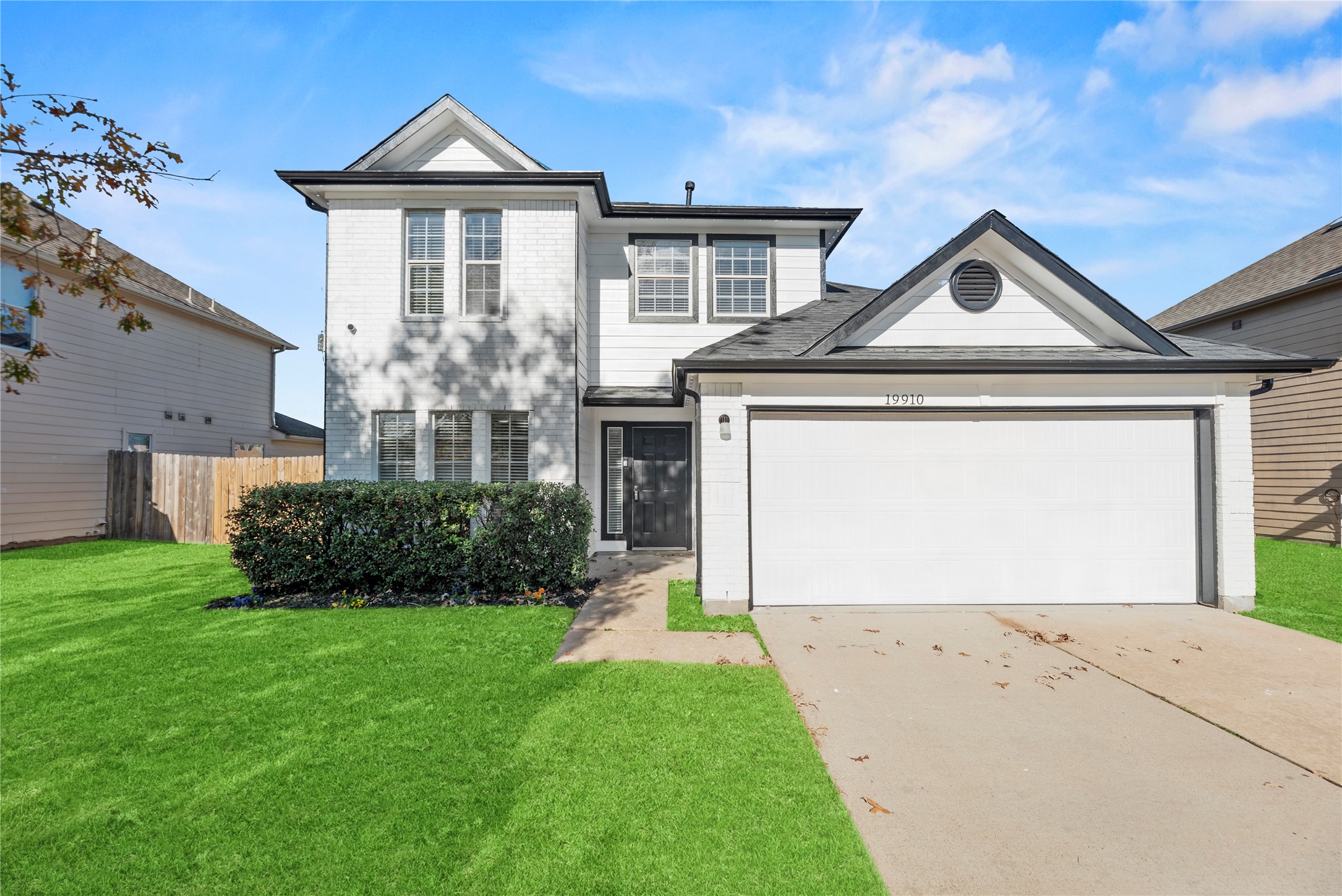 19910 Rustic Lake Lane Cypress, TX 77433 - Photo 1 of 21 a front view of a house with a yard and garage