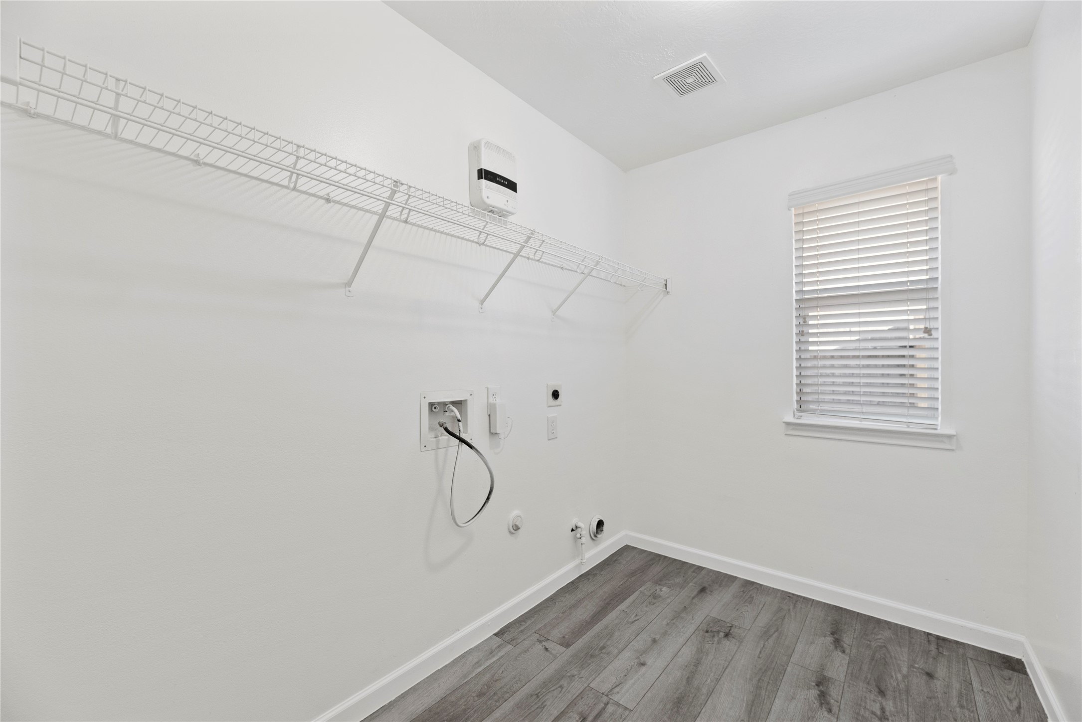 19910 Rustic Lake Lane Cypress, TX 77433 - Photo 14 of 21 a view of a room with racks on the wall