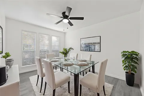 a view of a dining room with furniture and a potted plant