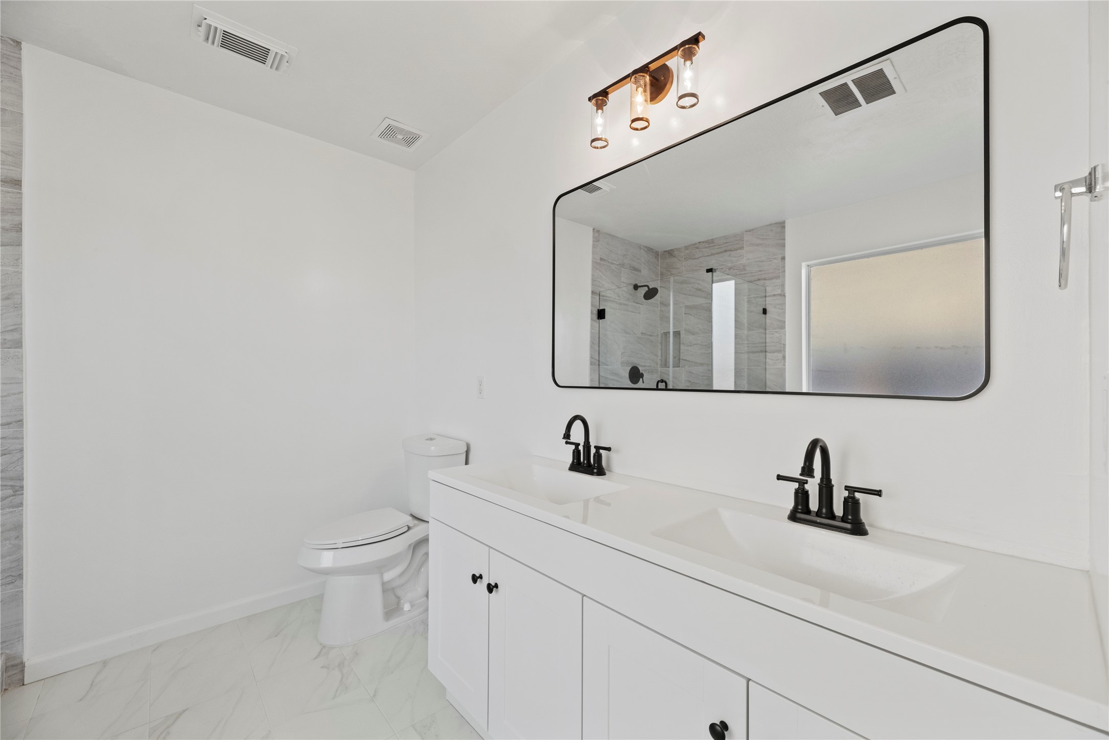 19910 Rustic Lake Lane Cypress, TX 77433 - Photo 9 of 21 a bathroom with a sink and a mirror