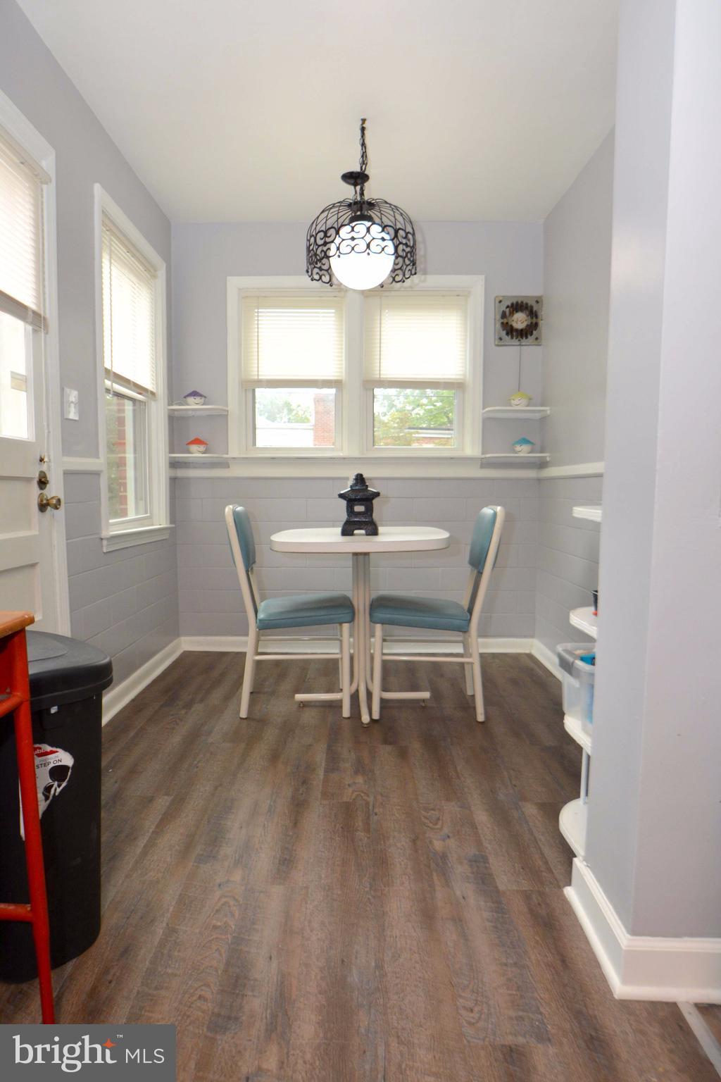 1738 Amuskai Road Baltimore, MD 21234 - Photo 5 of 20 a dining room with wooden floor a chandelier and windows