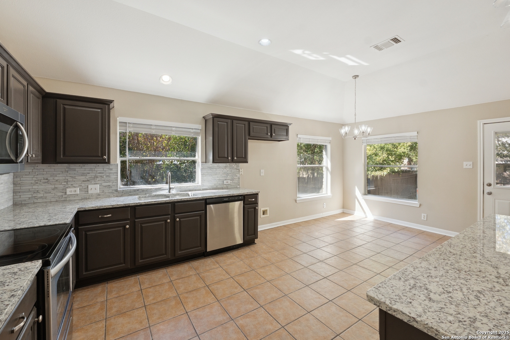 1815 Indian Paint Brush Road San Antonio, TX 78232 - Photo 14 of 38 a large kitchen with granite countertop a sink and a stove