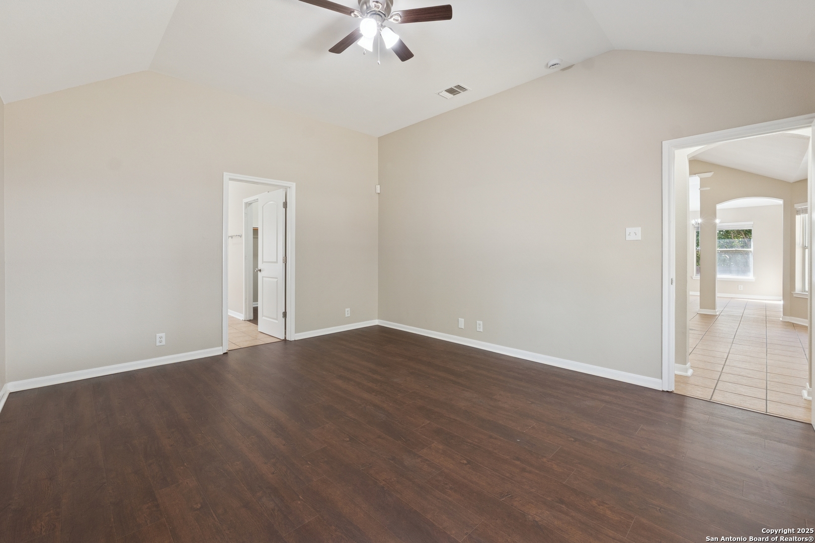 1815 Indian Paint Brush Road San Antonio, TX 78232 - Photo 19 of 38 an empty room with wooden floor fan and windows