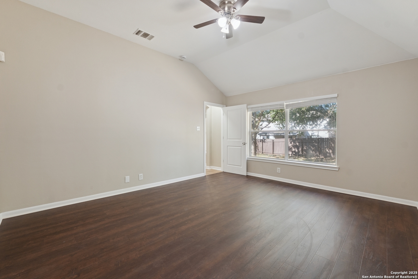 1815 Indian Paint Brush Road San Antonio, TX 78232 - Photo 20 of 38 a view of an empty room with wooden floor and a window