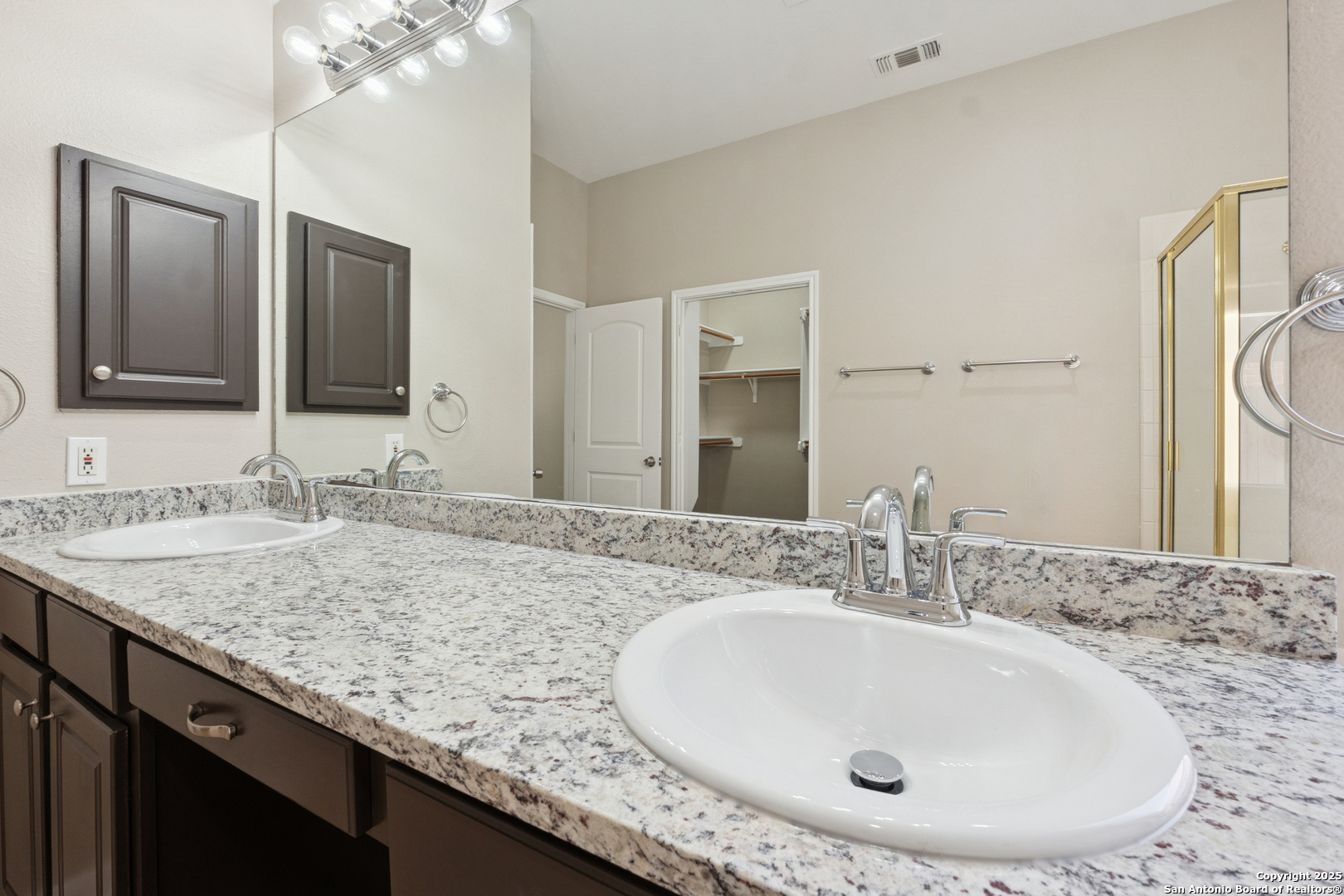 1815 Indian Paint Brush Road San Antonio, TX 78232 - Photo 23 of 38 a bathroom with a granite countertop sink and a mirror