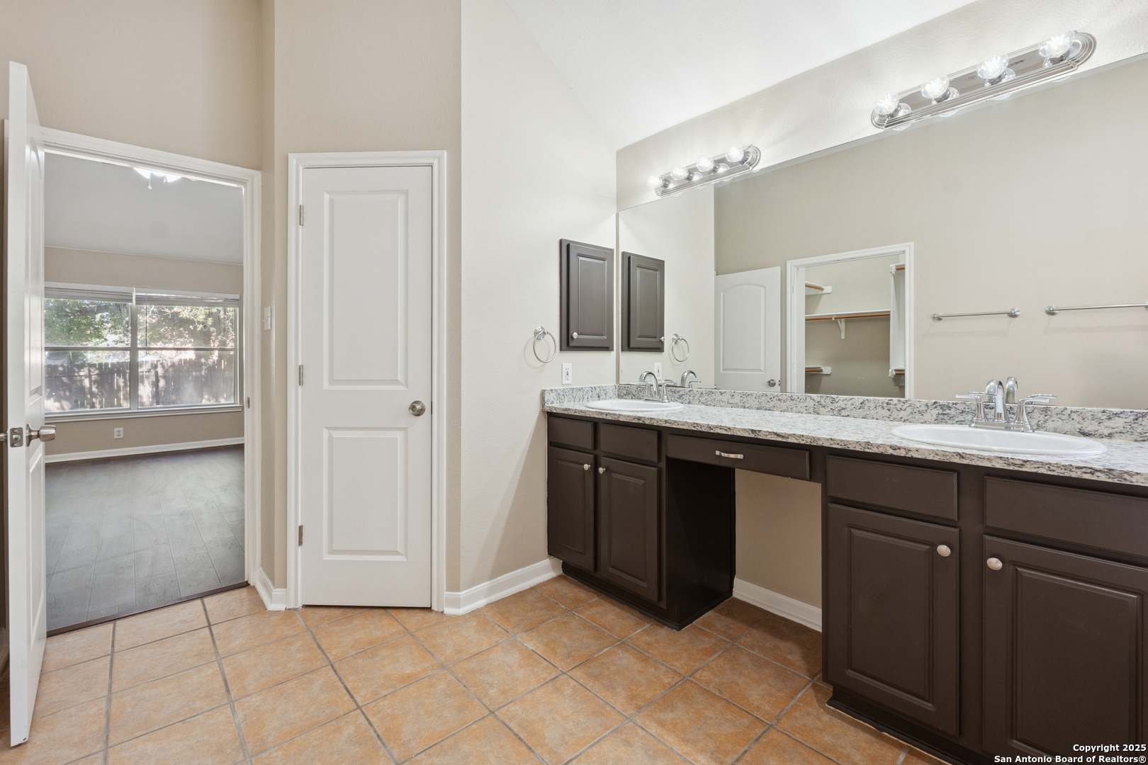1815 Indian Paint Brush Road San Antonio, TX 78232 - Photo 24 of 38 a spacious bathroom with a granite countertop double sink and mirror