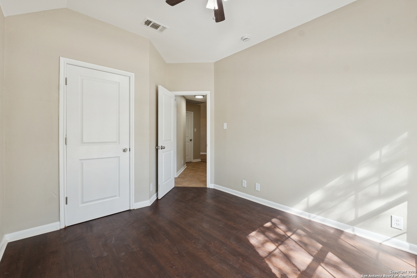 1815 Indian Paint Brush Road San Antonio, TX 78232 - Photo 29 of 38 an empty room with wooden floor and windows