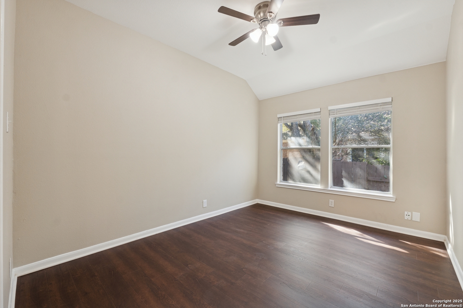 1815 Indian Paint Brush Road San Antonio, TX 78232 - Photo 30 of 38 an empty room with wooden floor fan and windows
