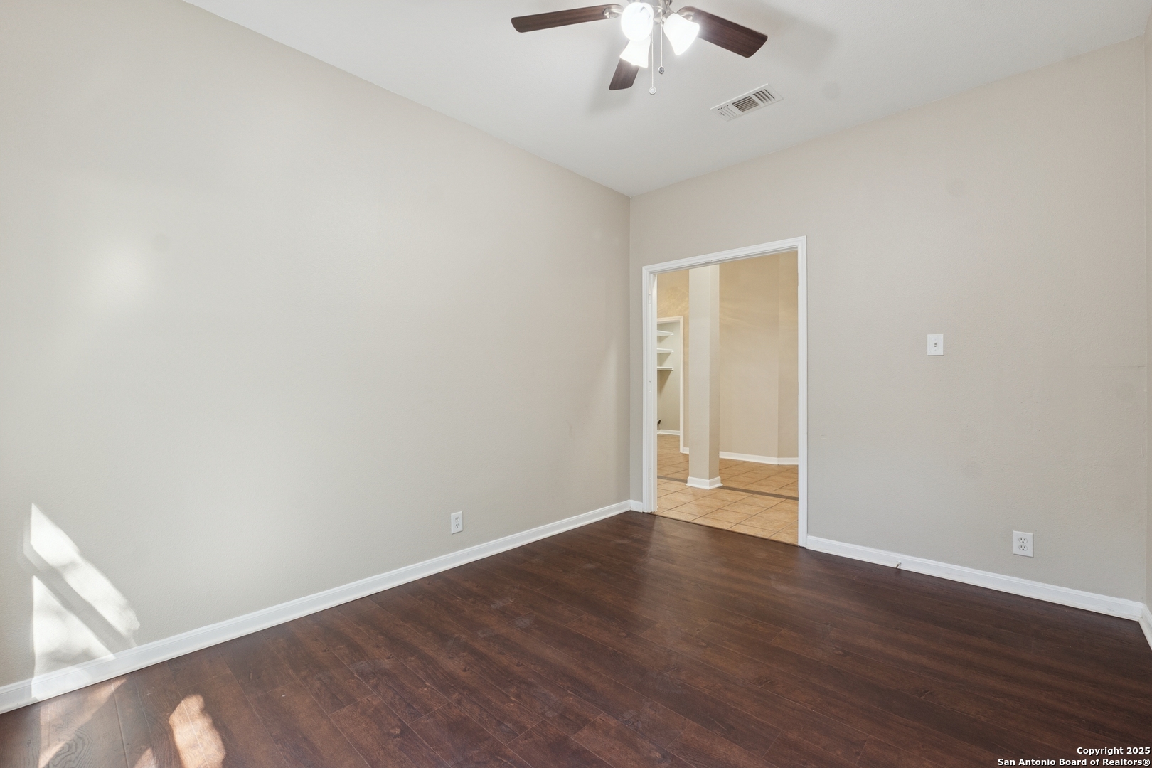 1815 Indian Paint Brush Road San Antonio, TX 78232 - Photo 31 of 38 an empty room with wooden floor and chandelier fan