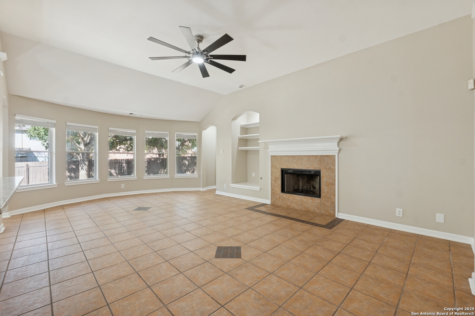 1815 Indian Paint Brush Road San Antonio, TX 78232 - Photo 7 of 38 a view of an empty room with a fireplace and a window