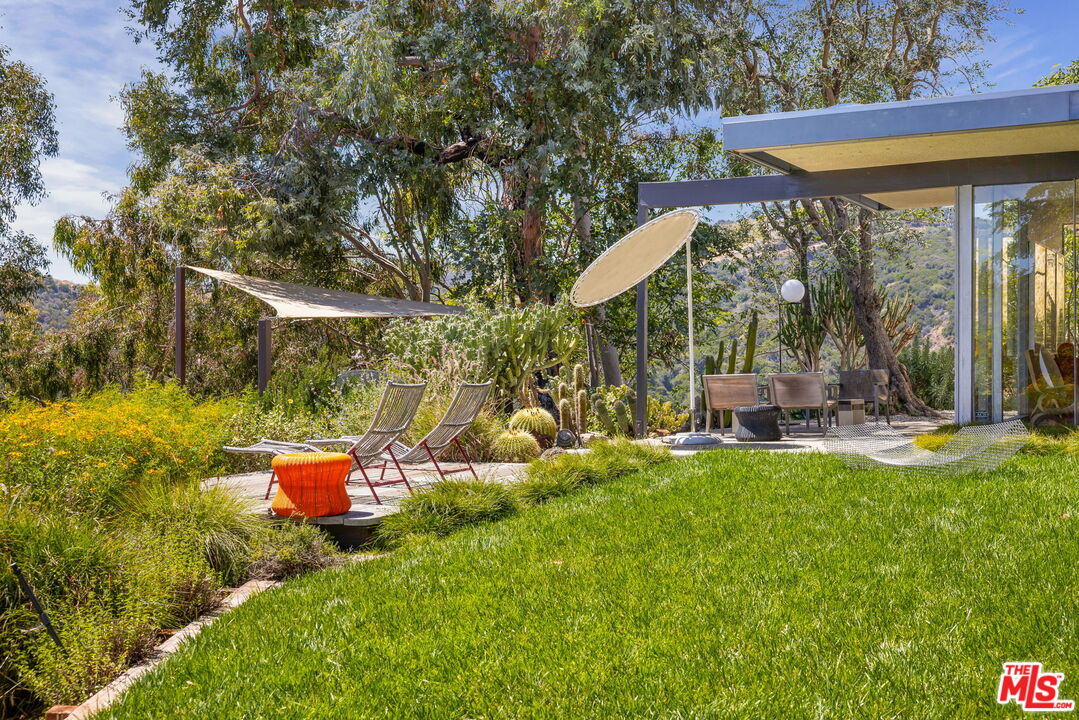 1531 North Tigertail Road Los Angeles, CA 90049 - Photo 11 of 24 a view of a chair and table in backyard of the house