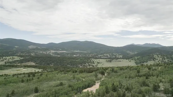 a view of a town with mountains in the background