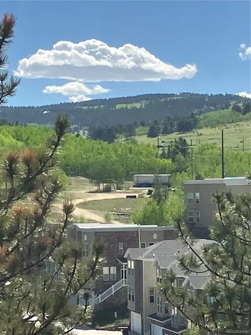 a view of a mountain range with lush green forest