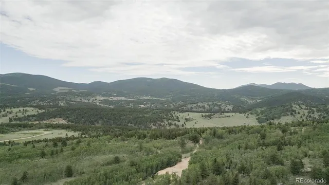 a view of a town with mountains in the background