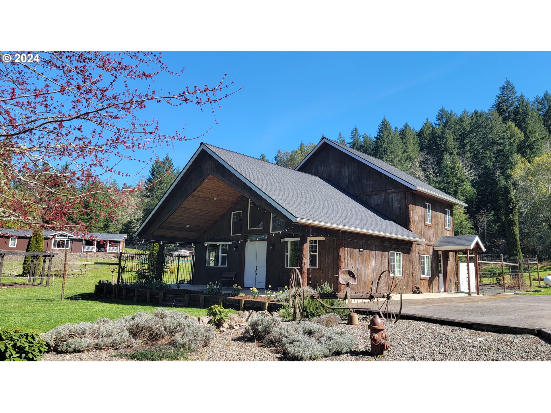 6910 Upper Olalla Road Winston, OR 97496 - Photo 1 of 48 a front view of a house with garden