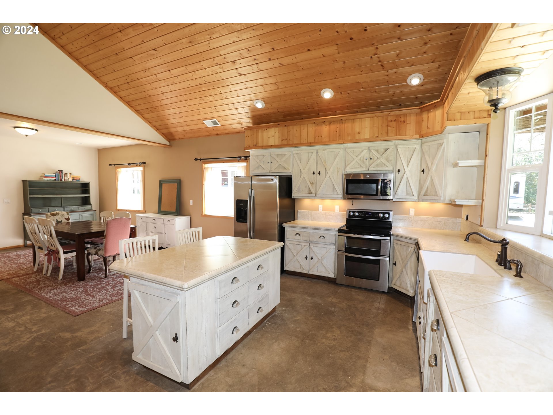 6910 Upper Olalla Road Winston, OR 97496 - Photo 11 of 48 a large white kitchen with kitchen island granite countertop lots of counter top space