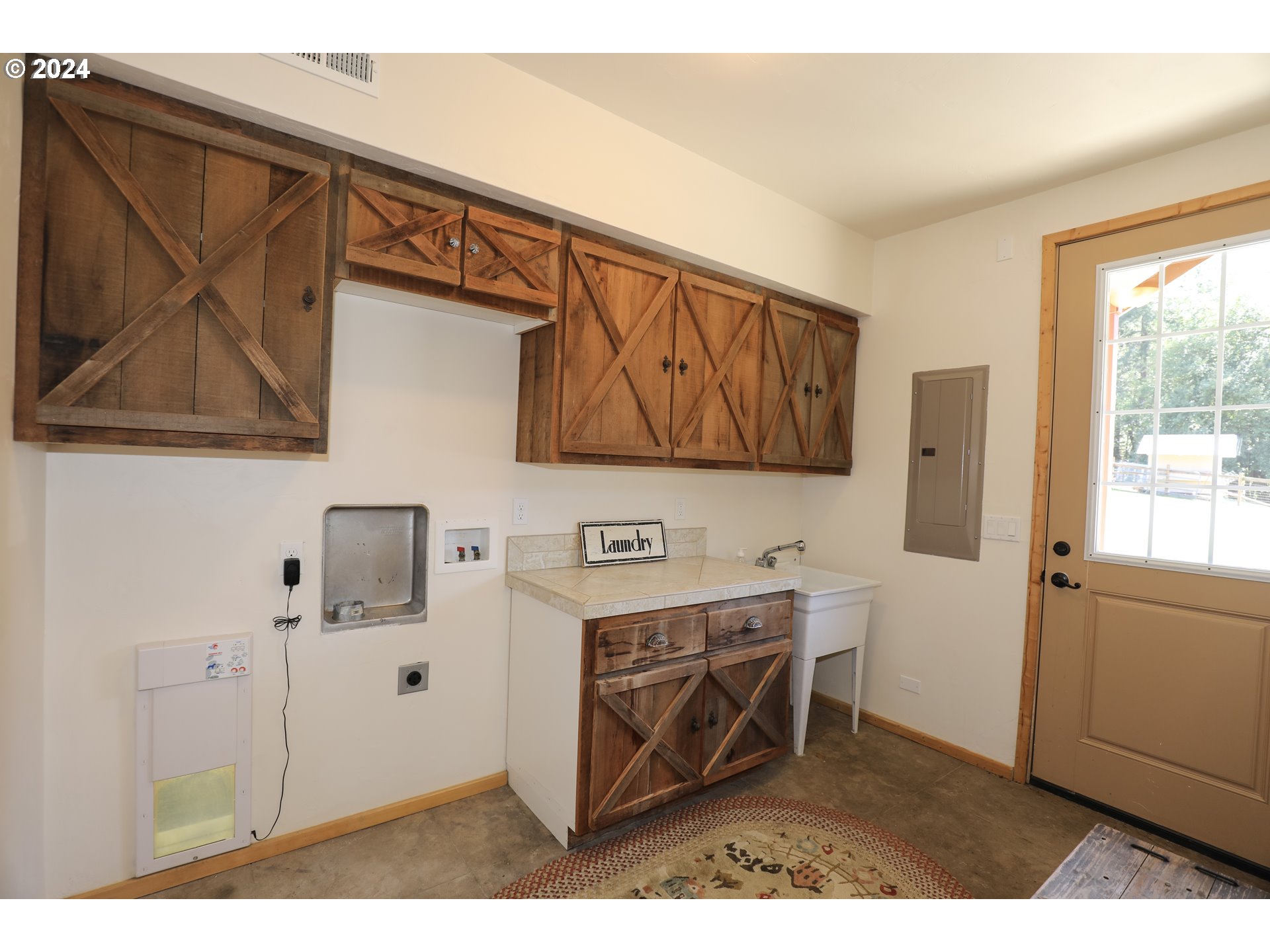 6910 Upper Olalla Road Winston, OR 97496 - Photo 13 of 48 a kitchen with stainless steel appliances kitchen island granite countertop a refrigerator a sink dishwasher with wooden cabinets