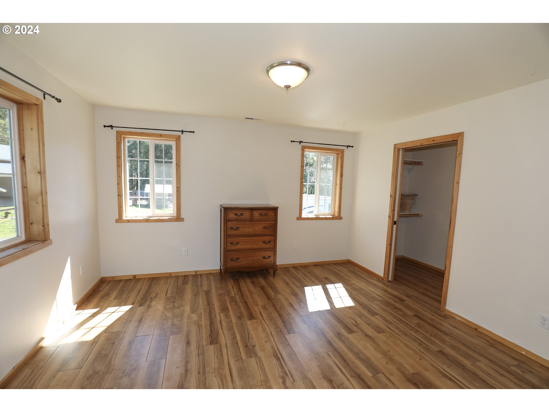 6910 Upper Olalla Road Winston, OR 97496 - Photo 17 of 48 a view of an empty room with a window and wooden floor