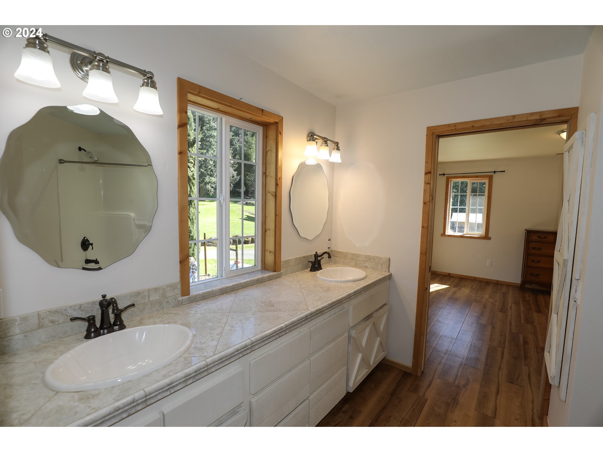 6910 Upper Olalla Road Winston, OR 97496 - Photo 18 of 48 a bathroom with a granite countertop sink mirror and vanity