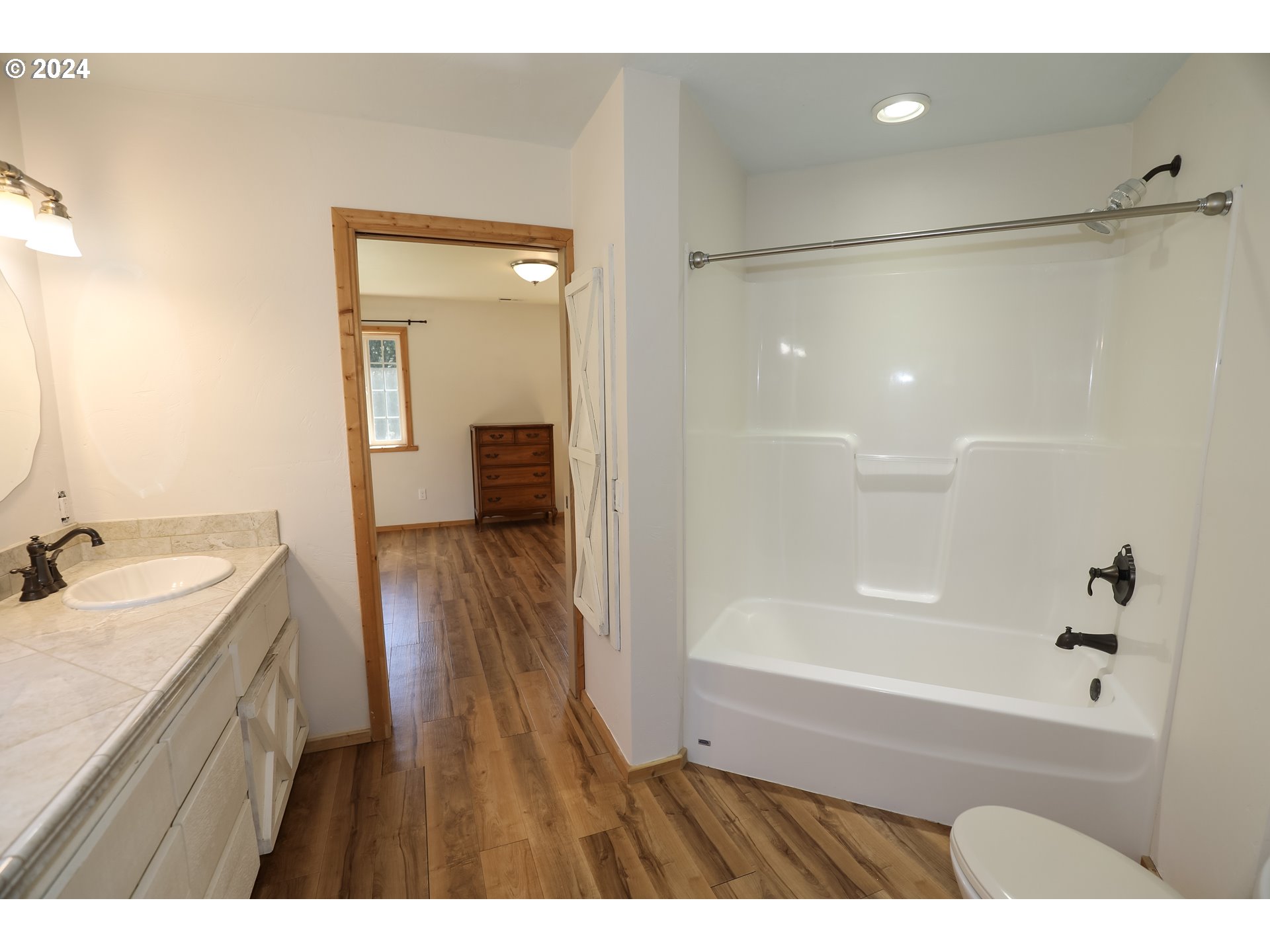 6910 Upper Olalla Road Winston, OR 97496 - Photo 19 of 48 a bathroom with a sink a mirror and a bathtub
