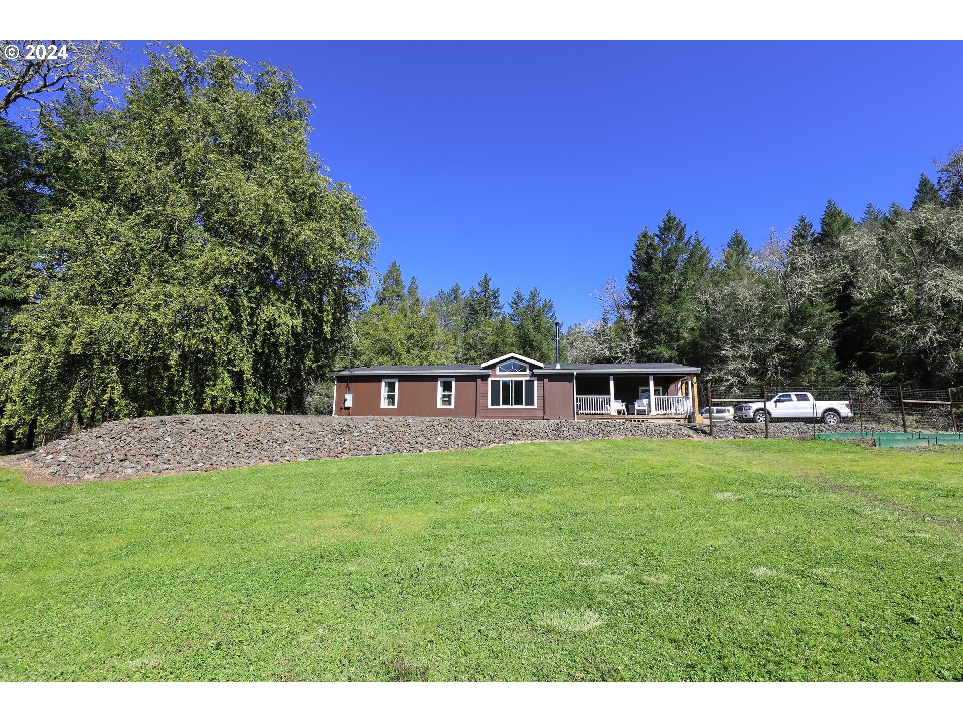 6910 Upper Olalla Road Winston, OR 97496 - Photo 20 of 48 a front view of a house with a yard
