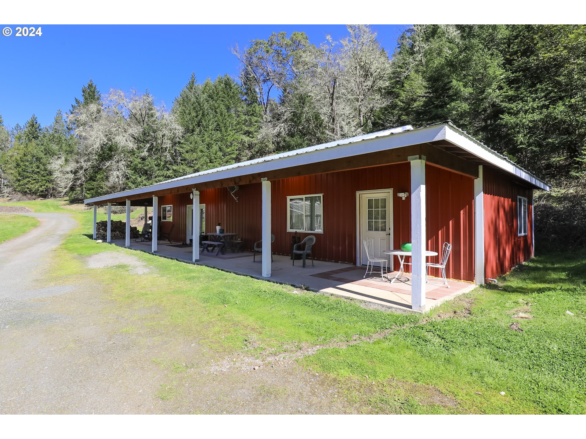 6910 Upper Olalla Road Winston, OR 97496 - Photo 31 of 48 a view of a house with a yard porch and sitting area
