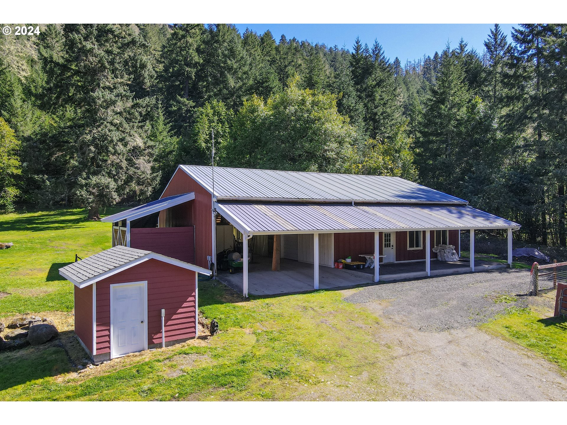 6910 Upper Olalla Road Winston, OR 97496 - Photo 36 of 48 a view of a house with a garden and sitting area