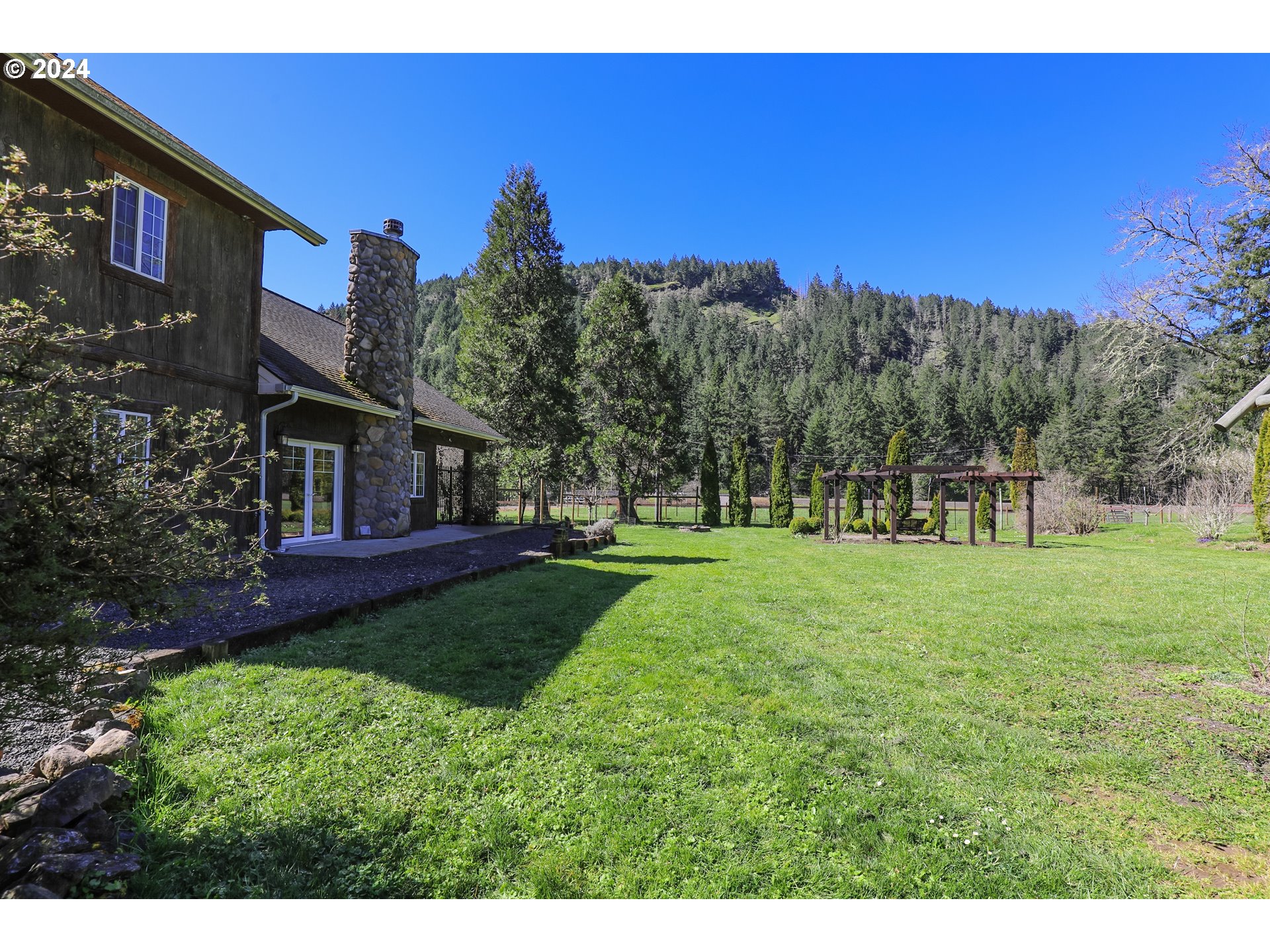 6910 Upper Olalla Road Winston, OR 97496 - Photo 4 of 48 a view of a house with a big yard