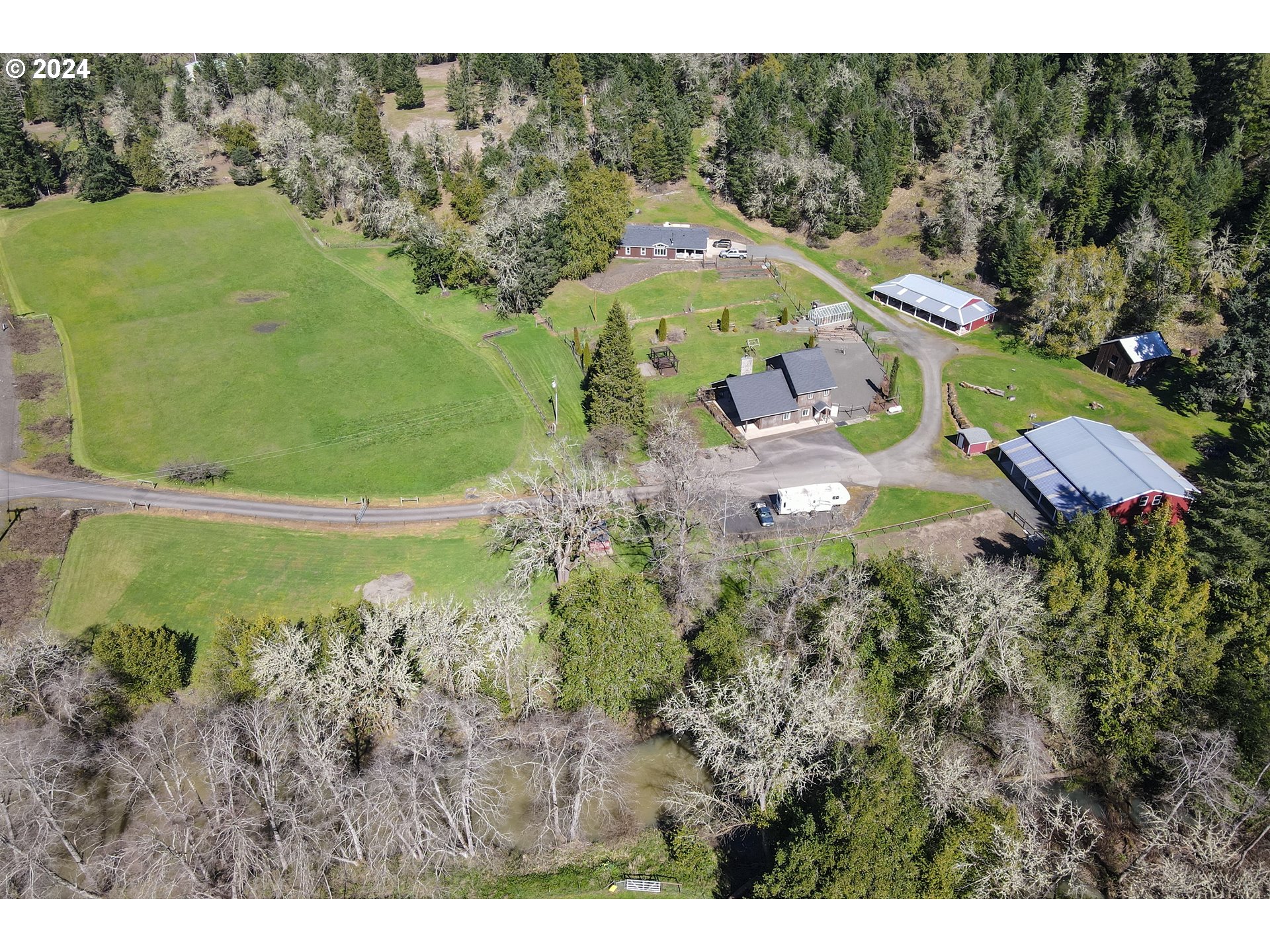 6910 Upper Olalla Road Winston, OR 97496 - Photo 6 of 48 a view of a house with a garden