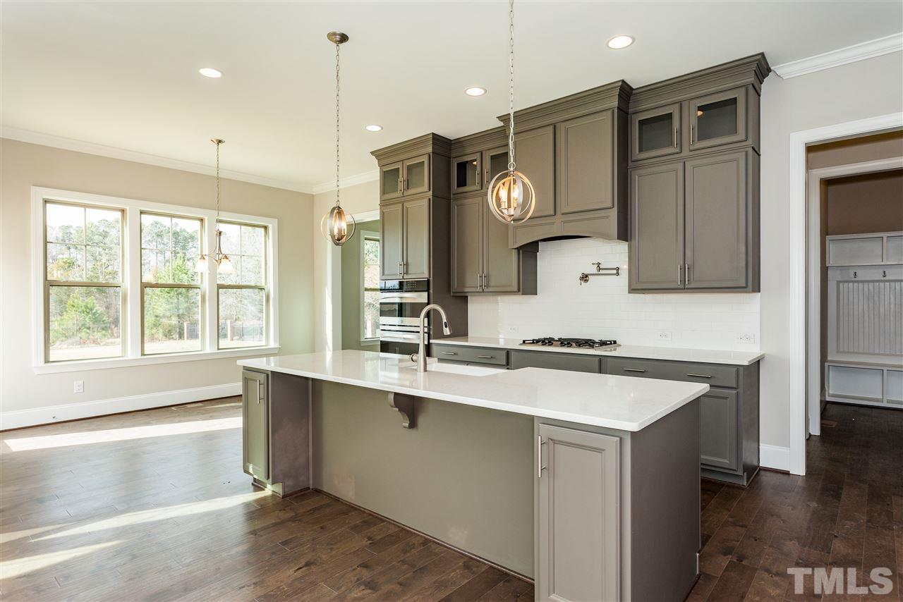 3316 Cotten Road, Unit 83 Raleigh, NC 27603 - Photo 2 of 21 a kitchen with a sink stove and cabinets