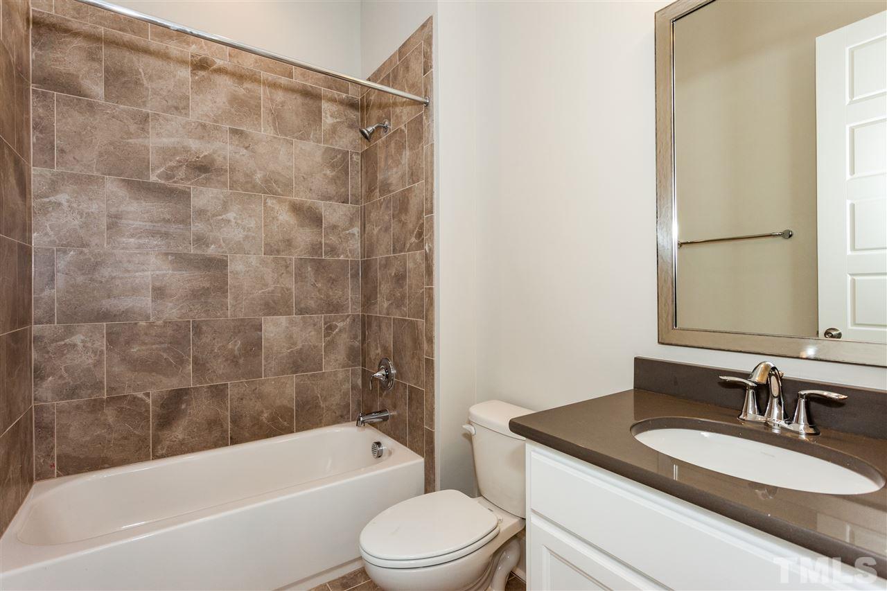 3316 Cotten Road, Unit 83 Raleigh, NC 27603 - Photo 4 of 21 a bathroom with a granite countertop sink toilet and shower