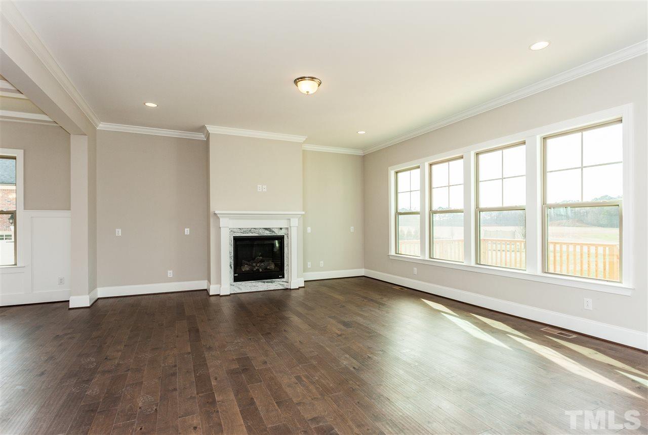 3316 Cotten Road, Unit 83 Raleigh, NC 27603 - Photo 7 of 21 an empty room with wooden floor and fireplace