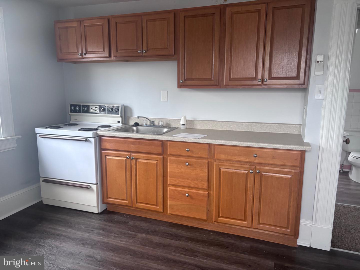 51 Oak Street Salem, NJ 08079 - Photo 2 of 5 a kitchen with stainless steel appliances granite countertop a sink dishwasher stove and cabinets