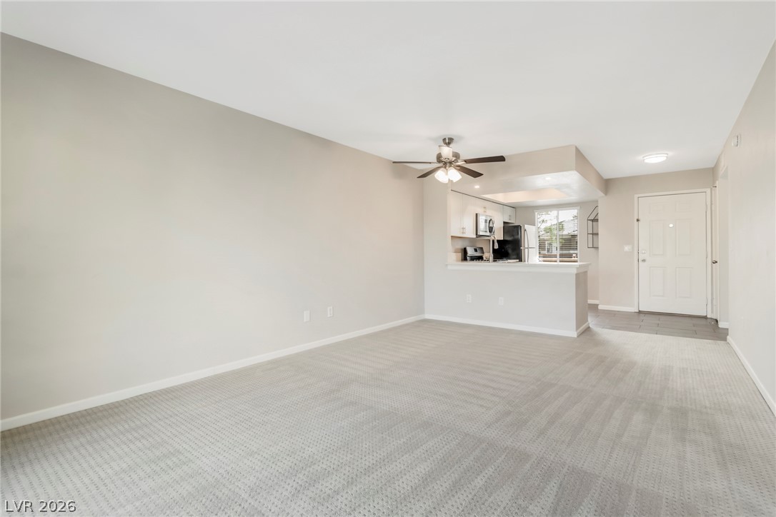 8070 West Russell Road, Unit 2006 Las Vegas, NV 89113 - Photo 14 of 24 A welcoming living space flows seamlessly into a well-appointed kitchen, ideal for relaxed entertaining.