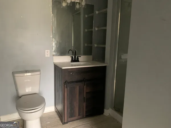 a bathroom with a toilet sink and mirror