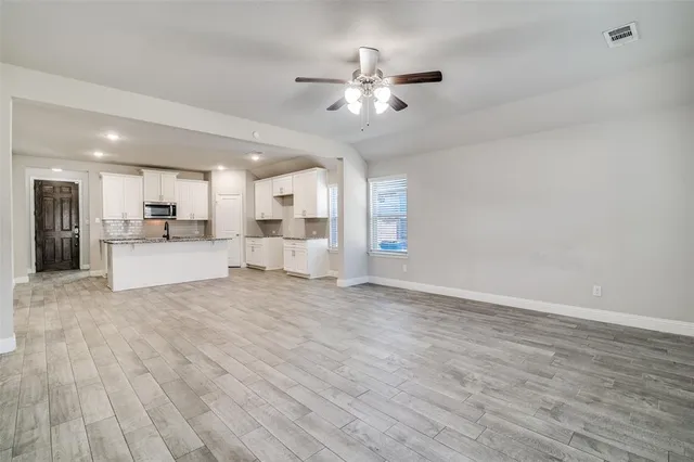 a view of a kitchen with a sink and a stove top oven